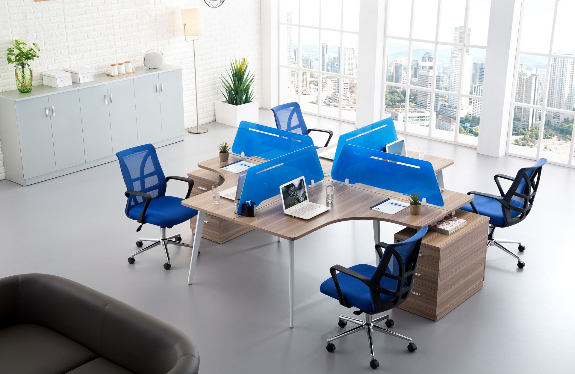 Modern open-plan office with blue workstations and storage cabinets